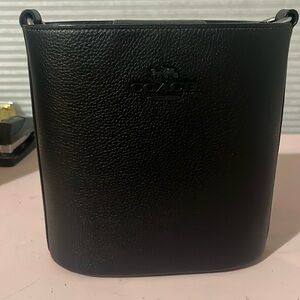 Coach Sophie Bucket bag with adjustable strap and magnet closure.Never worn.